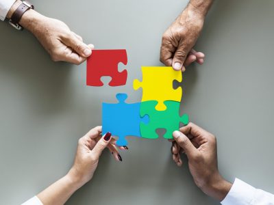 Business teamwork cooperation jigsaw isolated